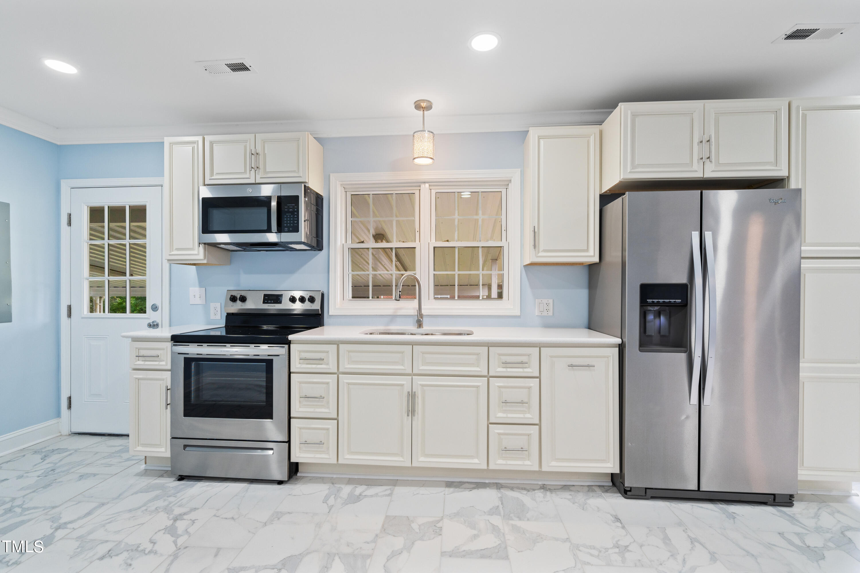 244 Semora Road Roxboro, NC 27573 - Photo 5 of 42 a kitchen with stainless steel appliances a stove microwave and a refrigerator