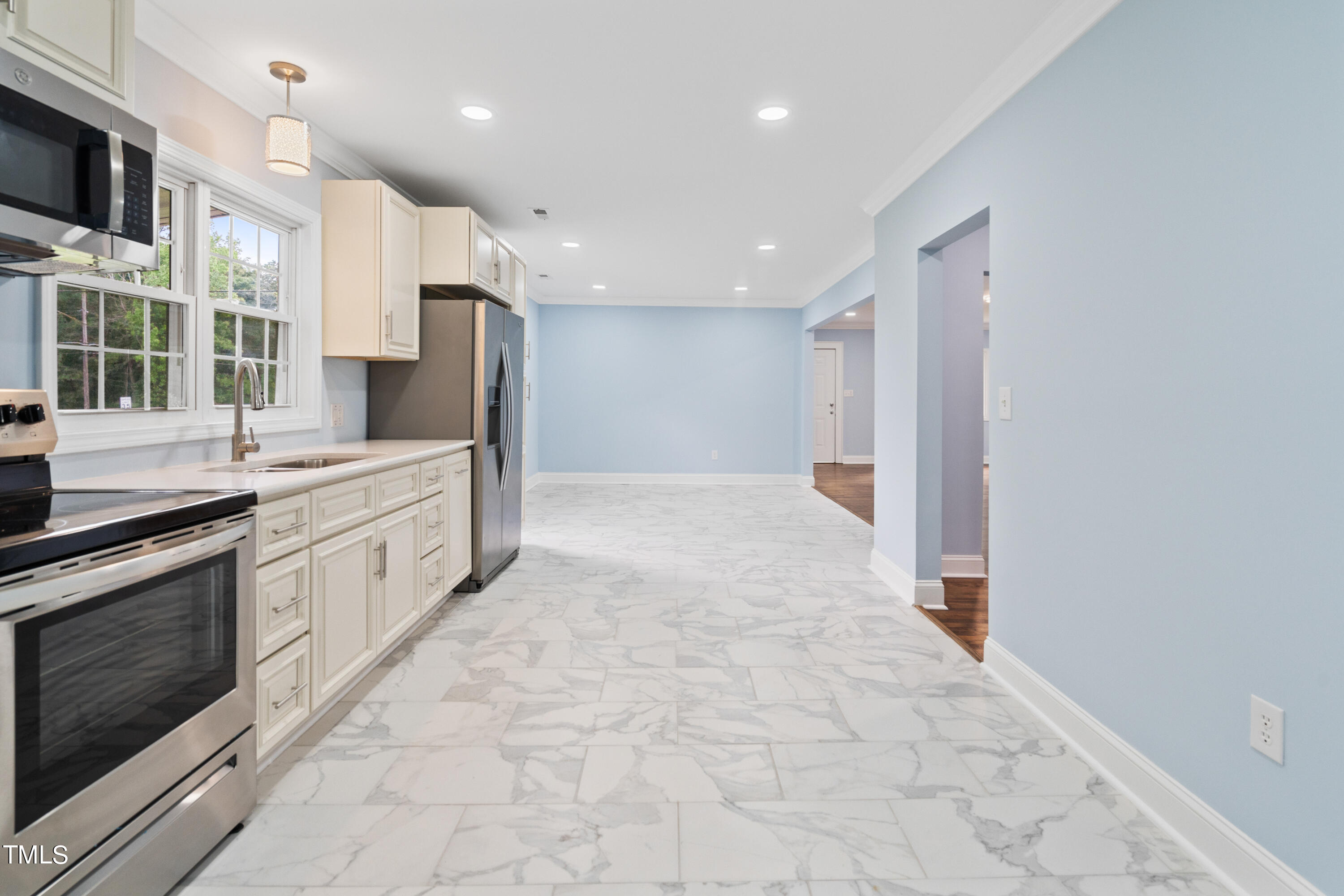 244 Semora Road Roxboro, NC 27573 - Photo 6 of 42 a large white kitchen with stainless steel appliances granite countertop a stove a sink and a microwave