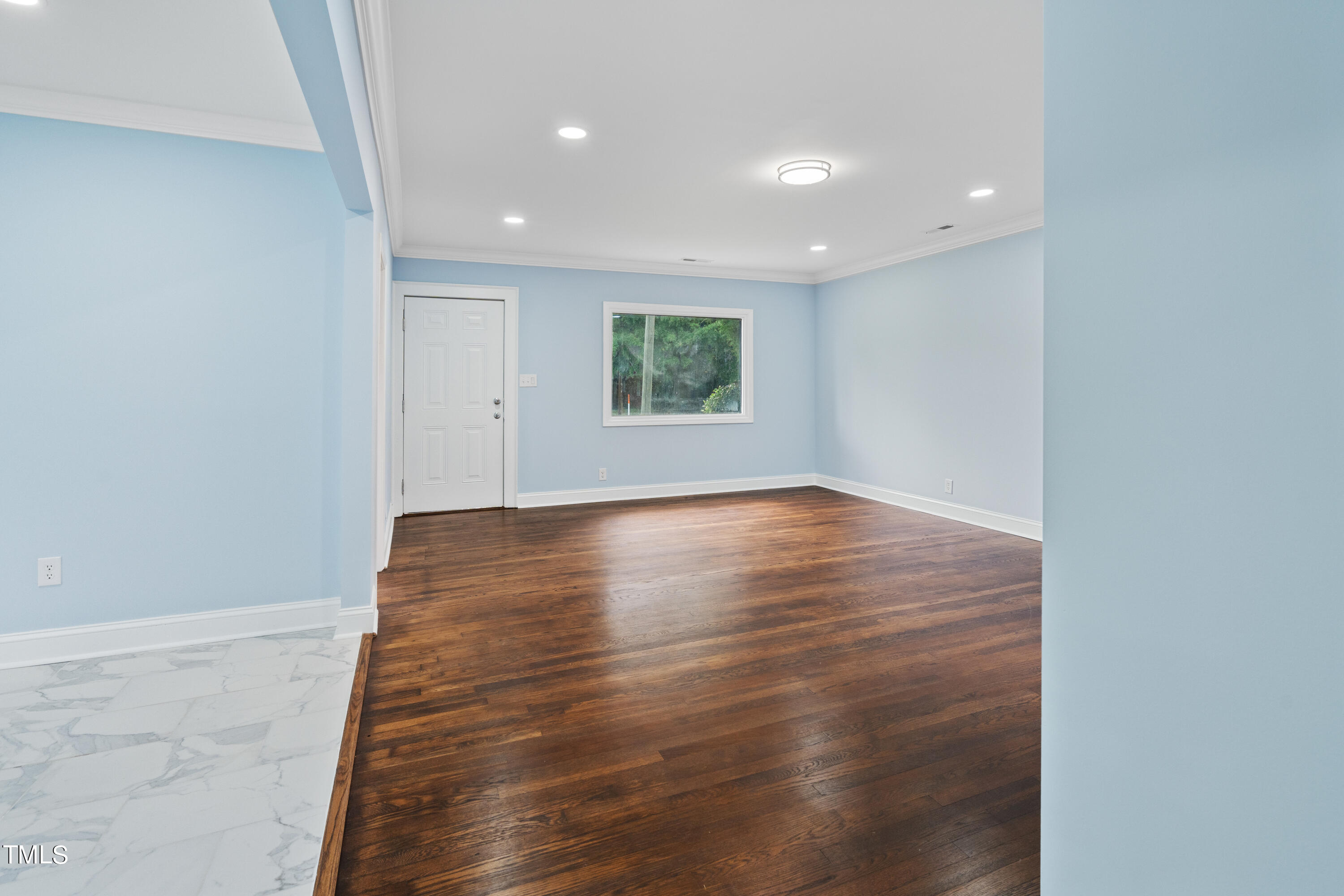 244 Semora Road Roxboro, NC 27573 - Photo 10 of 42 a view of room with window and wooden floor