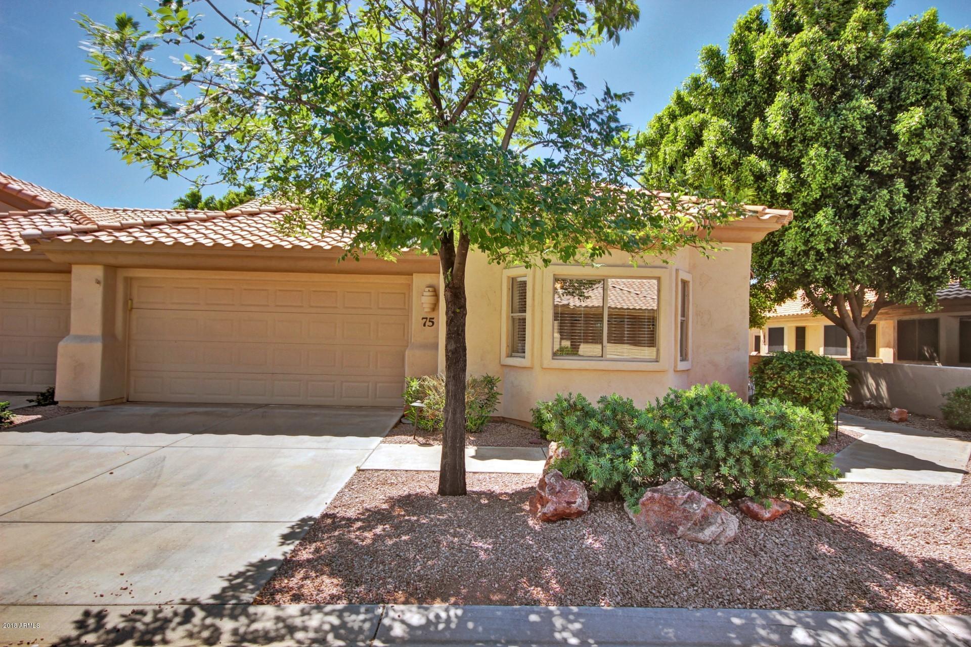 5830 East McKellips Road, Unit 75 Mesa, AZ 85215 - Photo 1 of 30 a front view of a house with garden