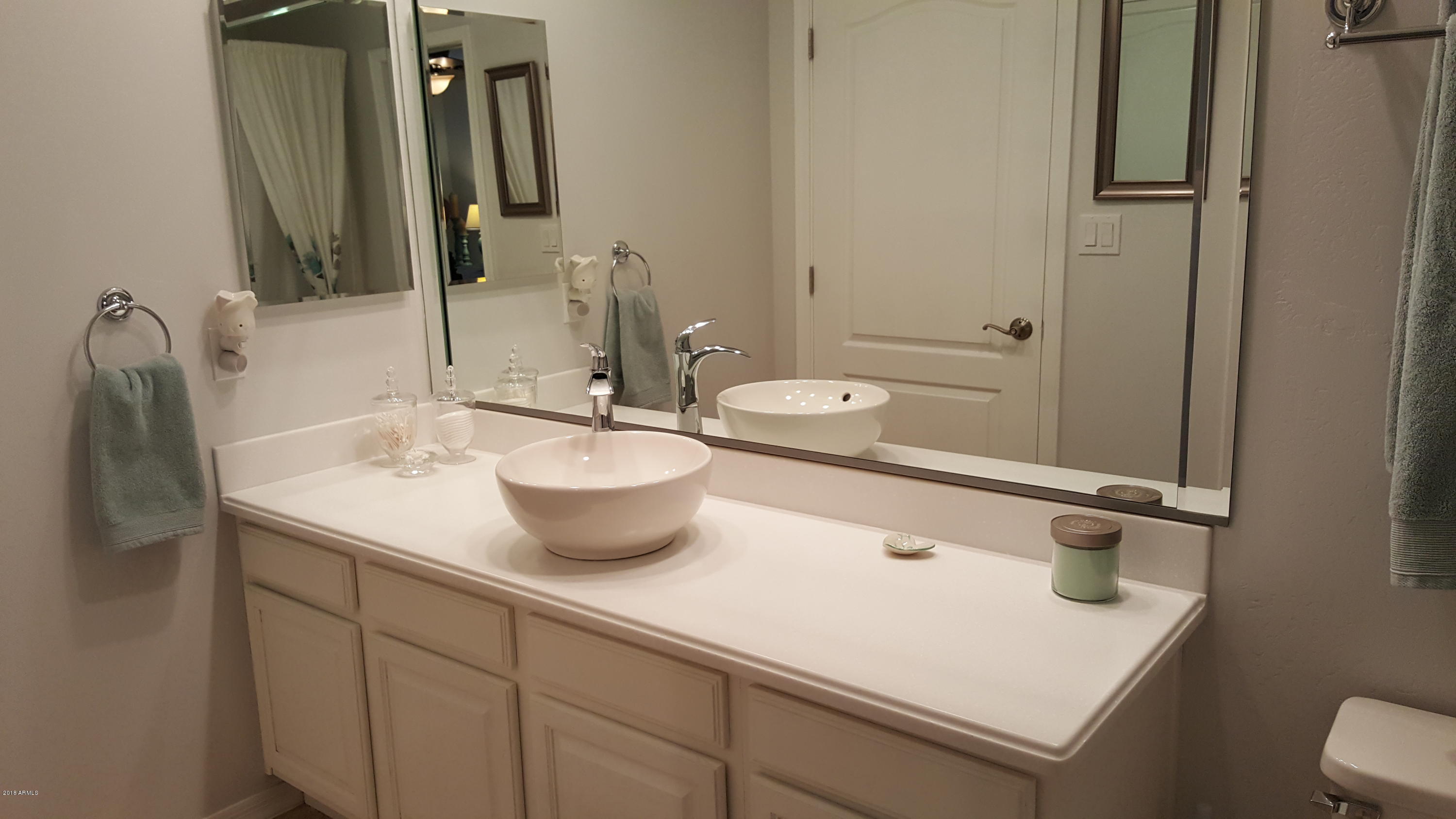 5830 East McKellips Road, Unit 75 Mesa, AZ 85215 - Photo 17 of 30 a bathroom with a sink and a mirror