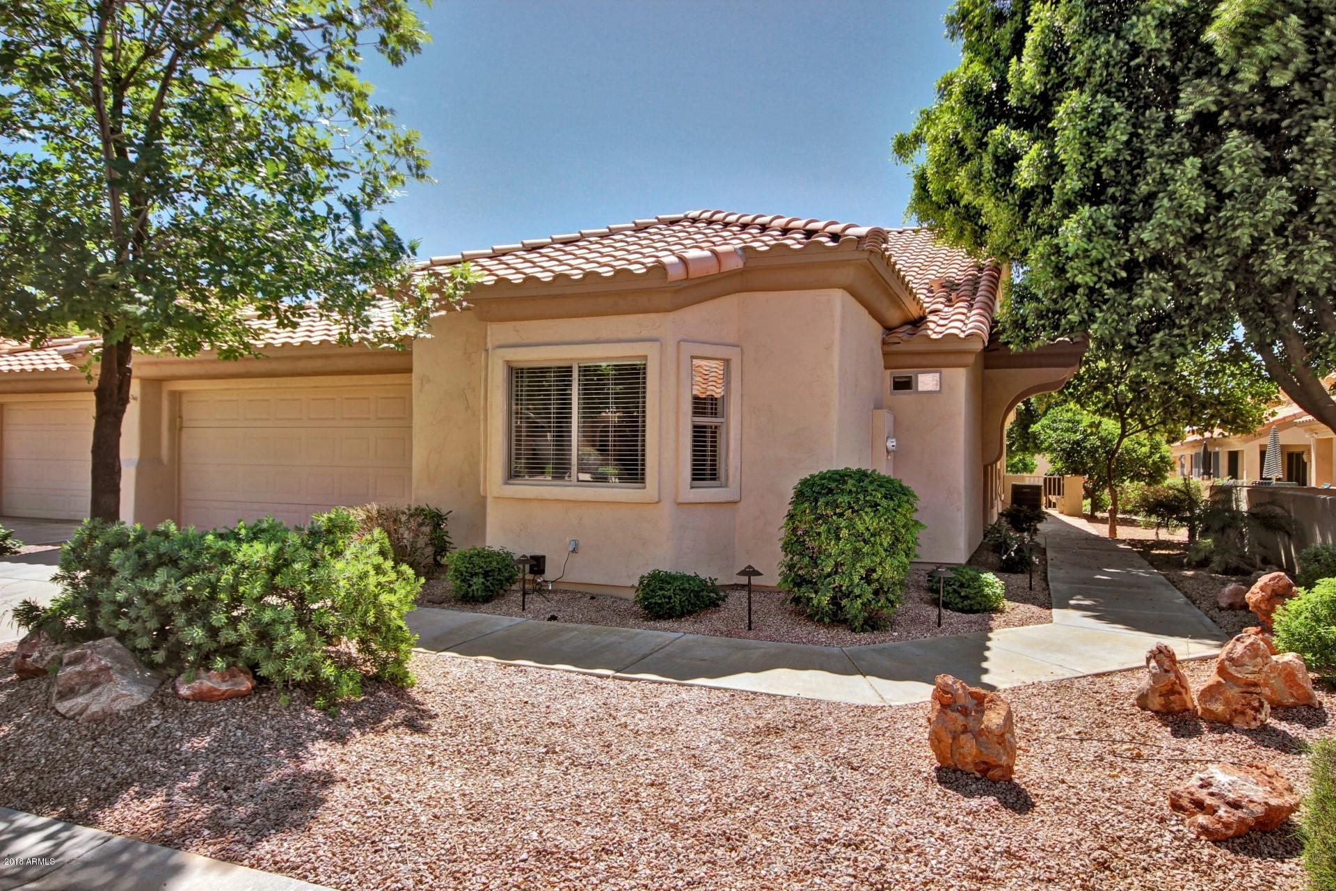 5830 East McKellips Road, Unit 75 Mesa, AZ 85215 - Photo 2 of 30 a front view of a house with a yard