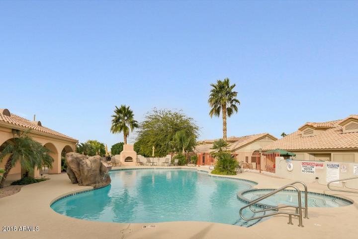 5830 East McKellips Road, Unit 75 Mesa, AZ 85215 - Photo 23 of 30 a view of a swimming pool with a table and chairs
