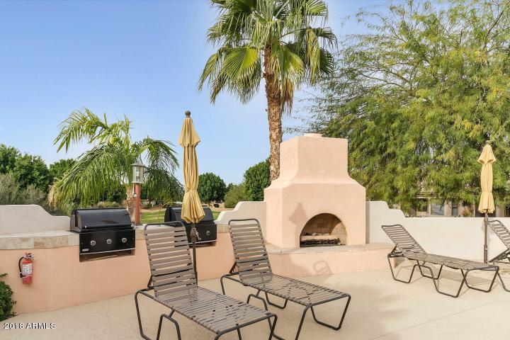 5830 East McKellips Road, Unit 75 Mesa, AZ 85215 - Photo 24 of 30 a view of a swimming pool with chairs