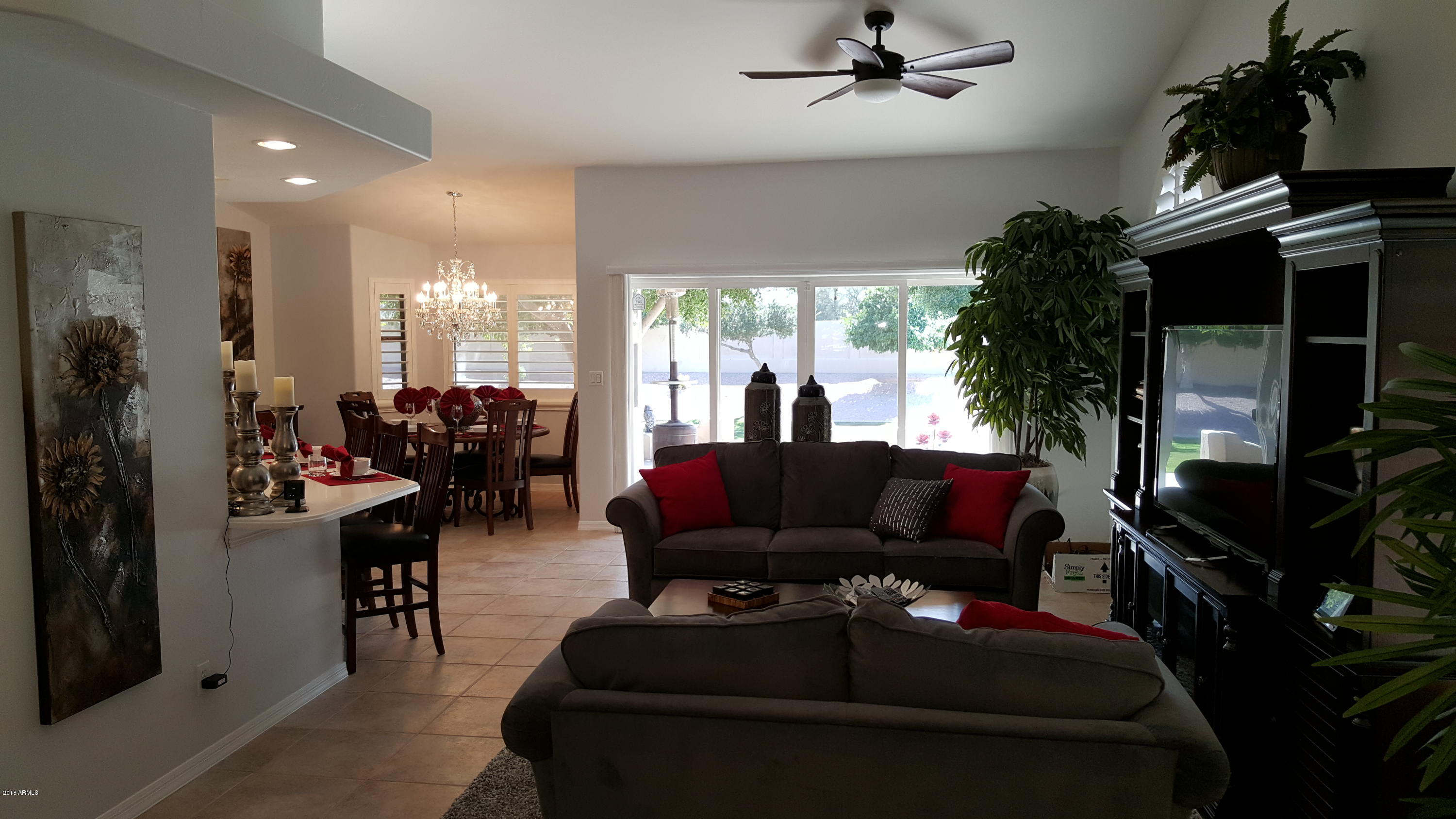5830 East McKellips Road, Unit 75 Mesa, AZ 85215 - Photo 3 of 30 a living room with furniture and a floor to ceiling window