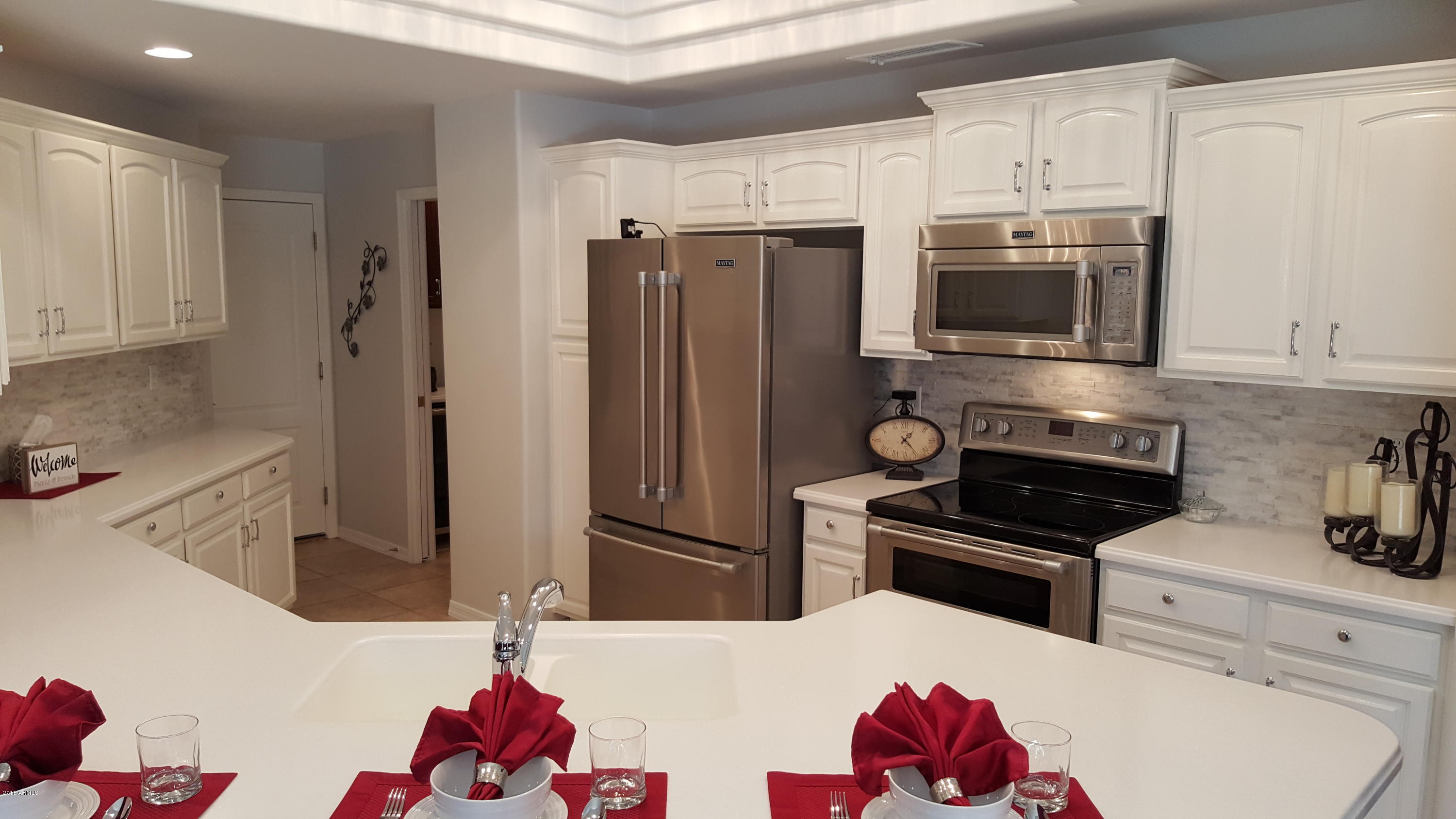 5830 East McKellips Road, Unit 75 Mesa, AZ 85215 - Photo 6 of 30 a kitchen with stainless steel appliances kitchen island granite countertop a refrigerator sink and stove