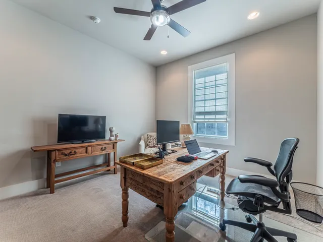 a bedroom with a bed and ceiling fan