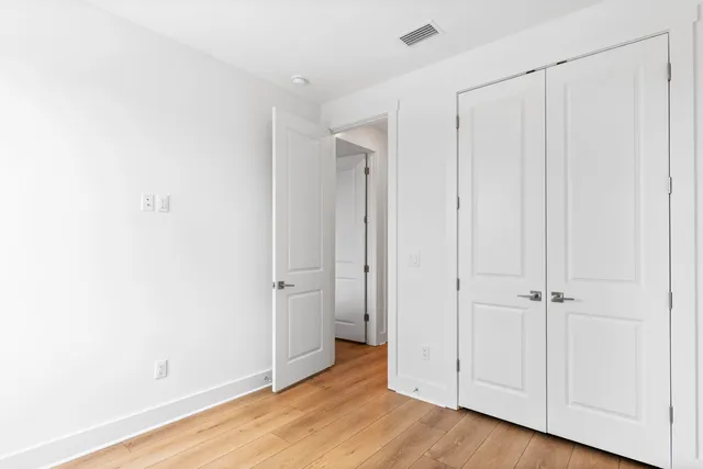 an empty room with wooden floor