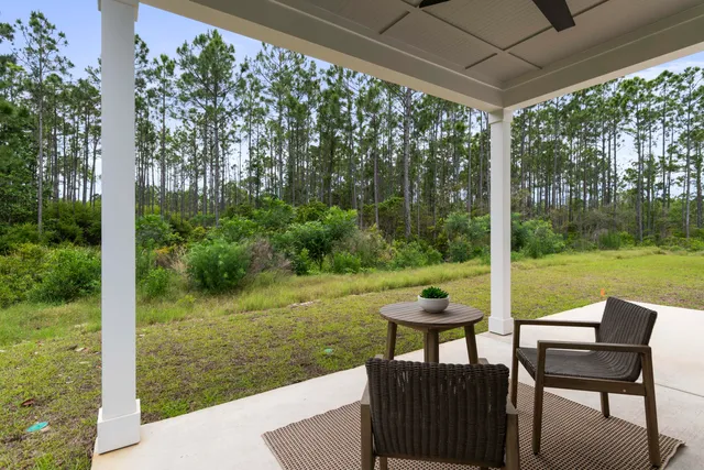 a view of a patio with a table chairs and a backyard