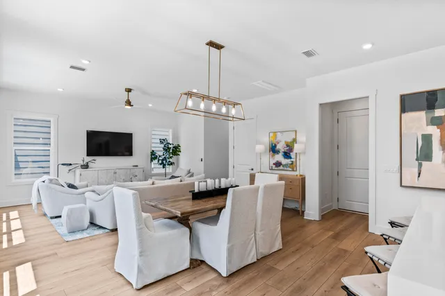a living room with furniture a rug and a flat screen tv