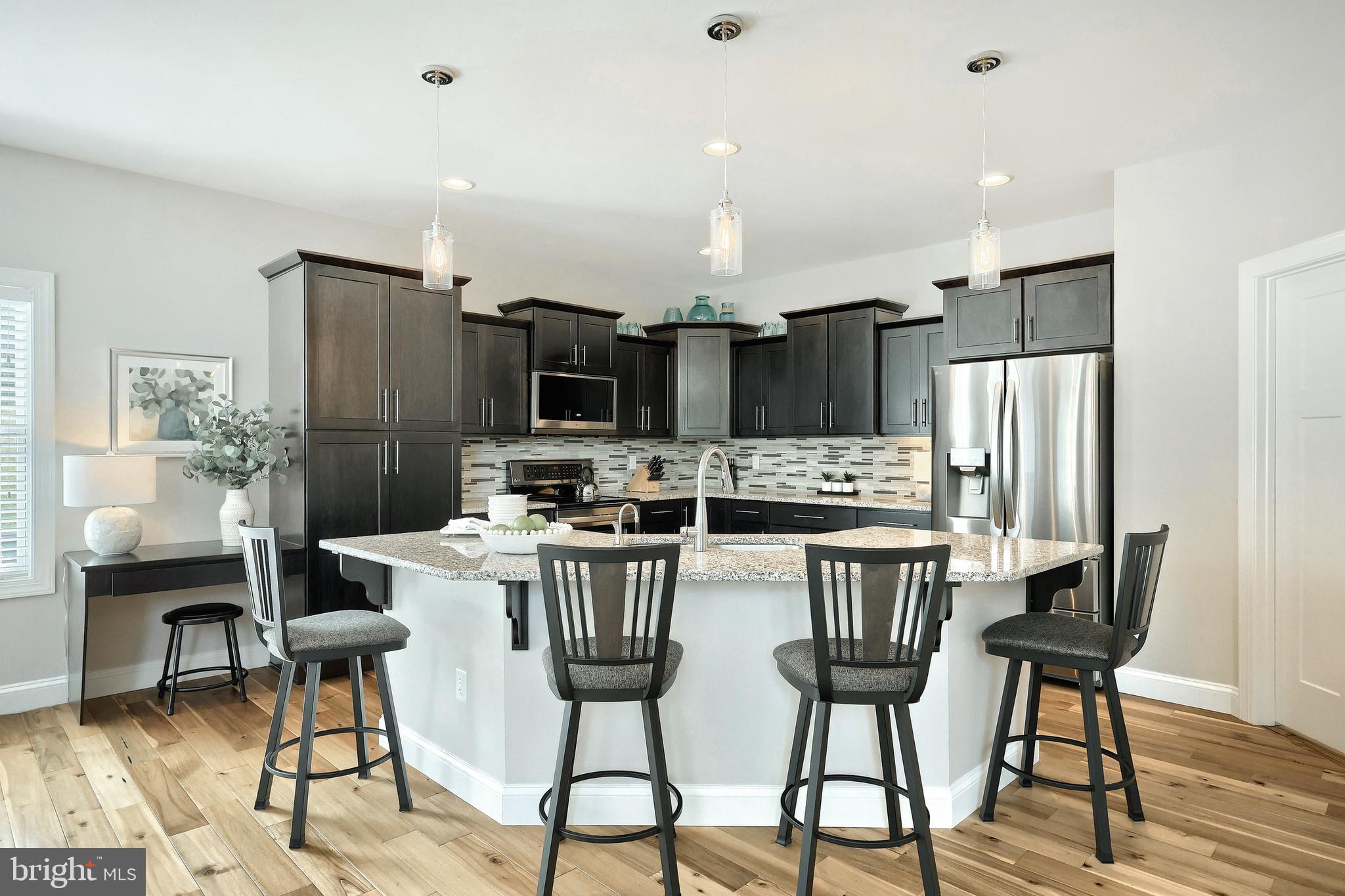 172 Fawn Hill Road Hanover, PA 17331 - Photo 42 of 71 a kitchen with stainless steel appliances a dining table chairs refrigerator and sink
