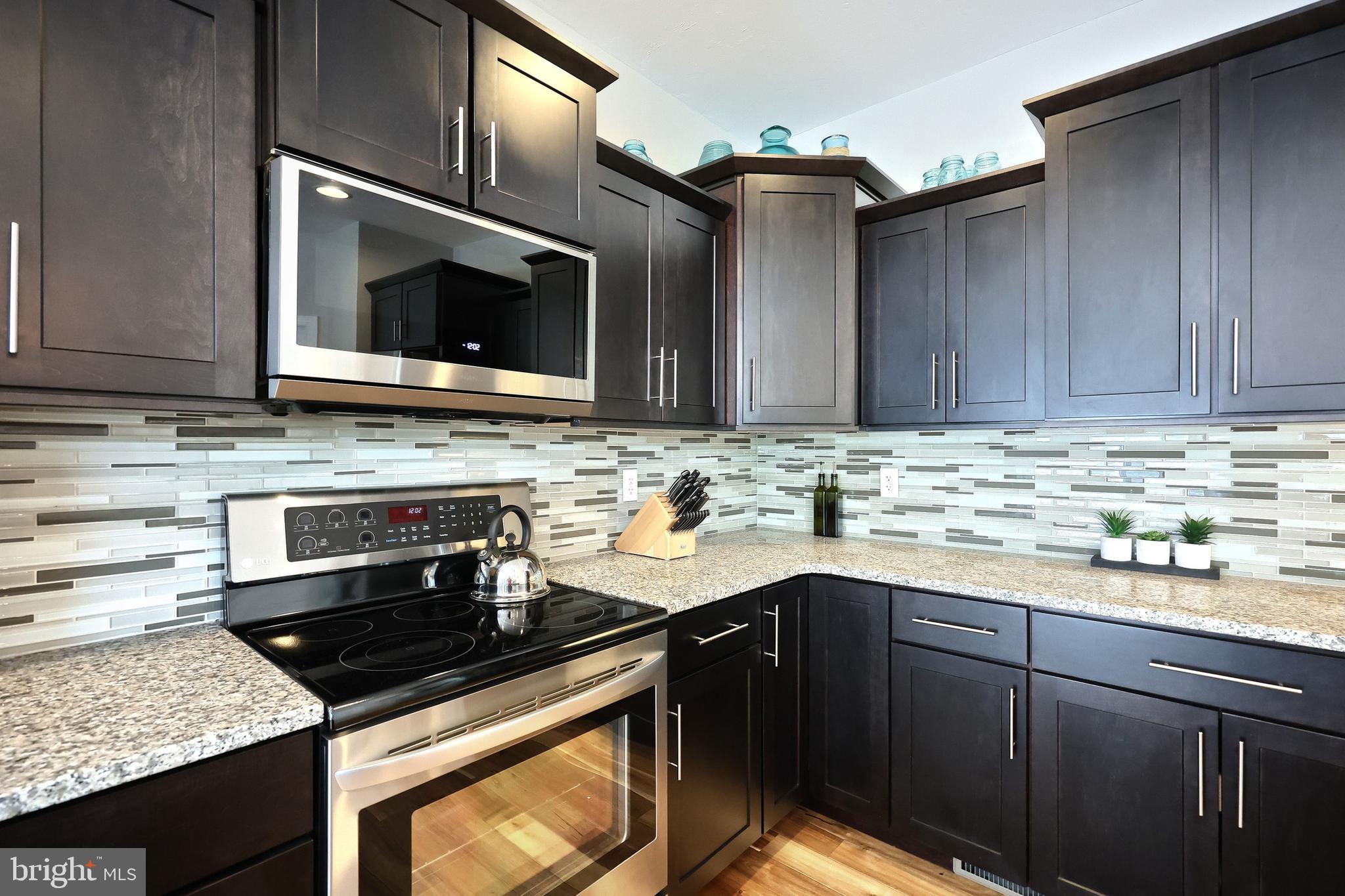 172 Fawn Hill Road Hanover, PA 17331 - Photo 44 of 71 a kitchen with stainless steel appliances granite countertop a sink stove and microwave