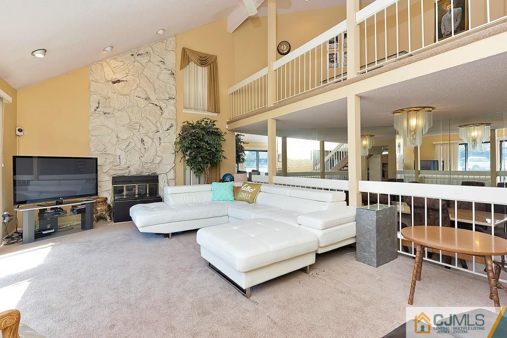 157 Westgate Drive Edison, NJ 08820 - Photo 2 of 12 a living room with furniture and a flat screen tv