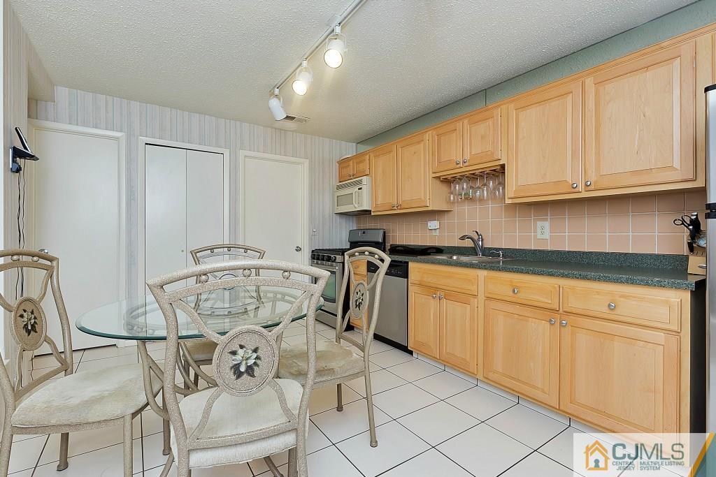 157 Westgate Drive Edison, NJ 08820 - Photo 4 of 12 a kitchen with a sink cabinets and appliances