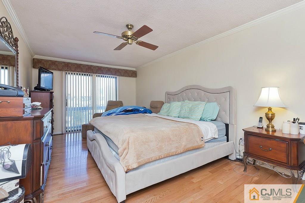 157 Westgate Drive Edison, NJ 08820 - Photo 7 of 12 a bedroom with a bed and wooden floor