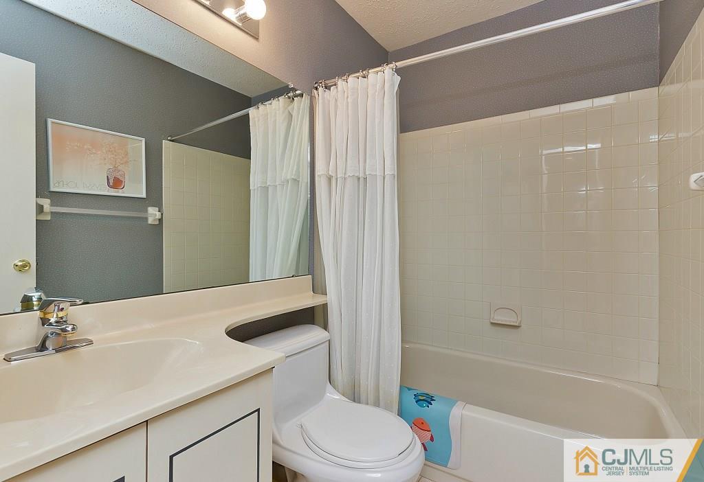 157 Westgate Drive Edison, NJ 08820 - Photo 8 of 12 a bathroom with a sink a toilet and shower