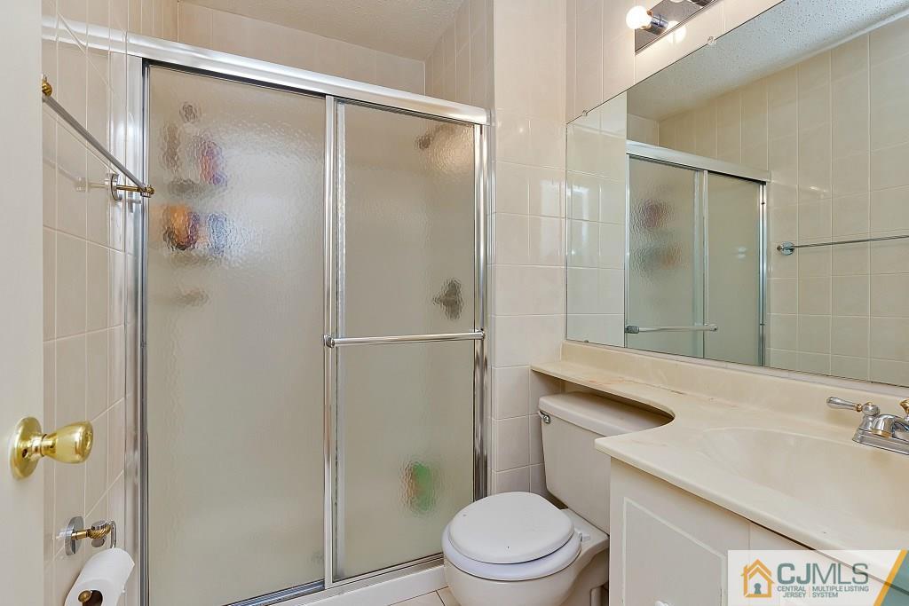 157 Westgate Drive Edison, NJ 08820 - Photo 10 of 12 a bathroom with a sink toilet and shower