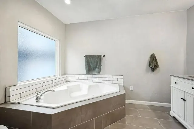 a bathroom with a bathtub and shower