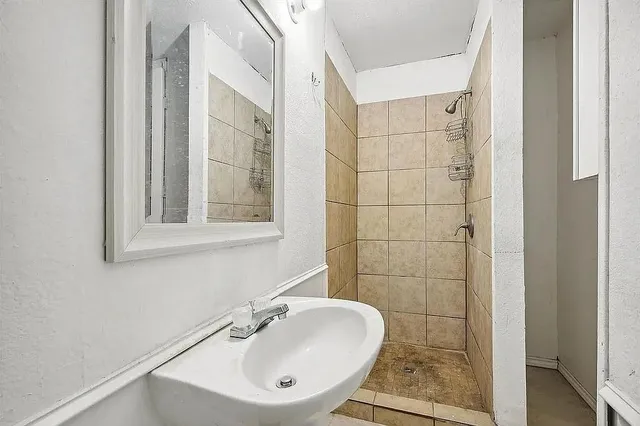a bathroom with a sink a toilet and a mirror