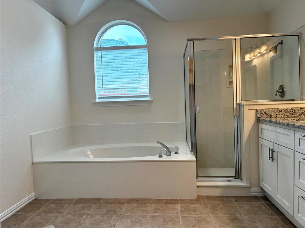 7936 Tournament Road Frisco, TX 75035 - Photo 15 of 28 a bathroom with a bathtub and a shower
