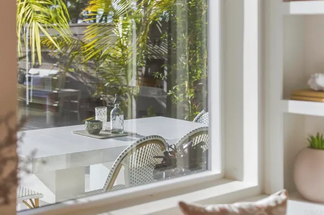 a dining room with wooden floor a chandelier a wooden table and chairs