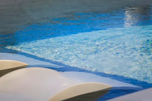 a view of swimming pool with outdoor seating