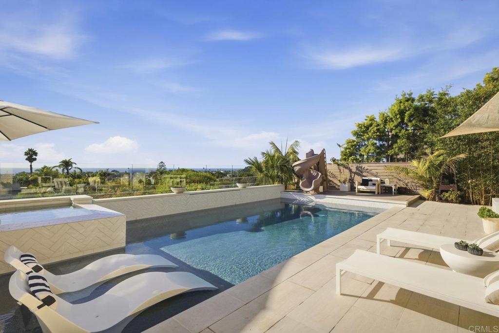 870 Hymettus Avenue Encinitas, CA 92024 - Photo 52 of 74 a view of a patio with couches and table under an umbrella