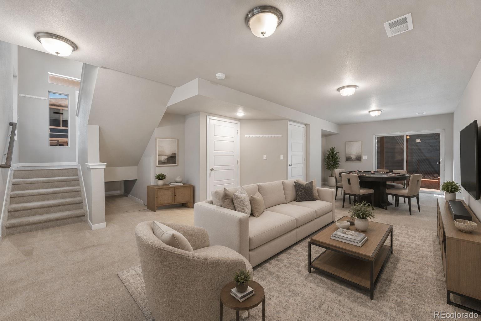 9528 Timberlake Loop Colorado Springs, CO 80927 - Photo 28 of 37 a living room with furniture and a flat screen tv