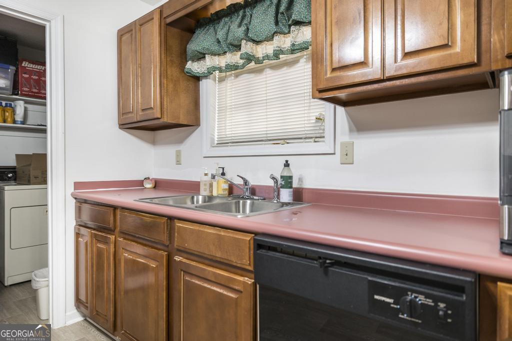 904 Robinhood Road Dublin, GA 31021 - Photo 14 of 29 a kitchen with stainless steel appliances a sink a stove and cabinets