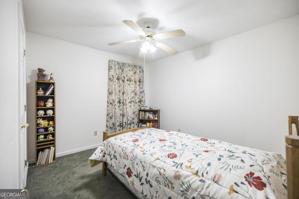 904 Robinhood Road Dublin, GA 31021 - Photo 18 of 29 a bedroom with a bed and a book shelf