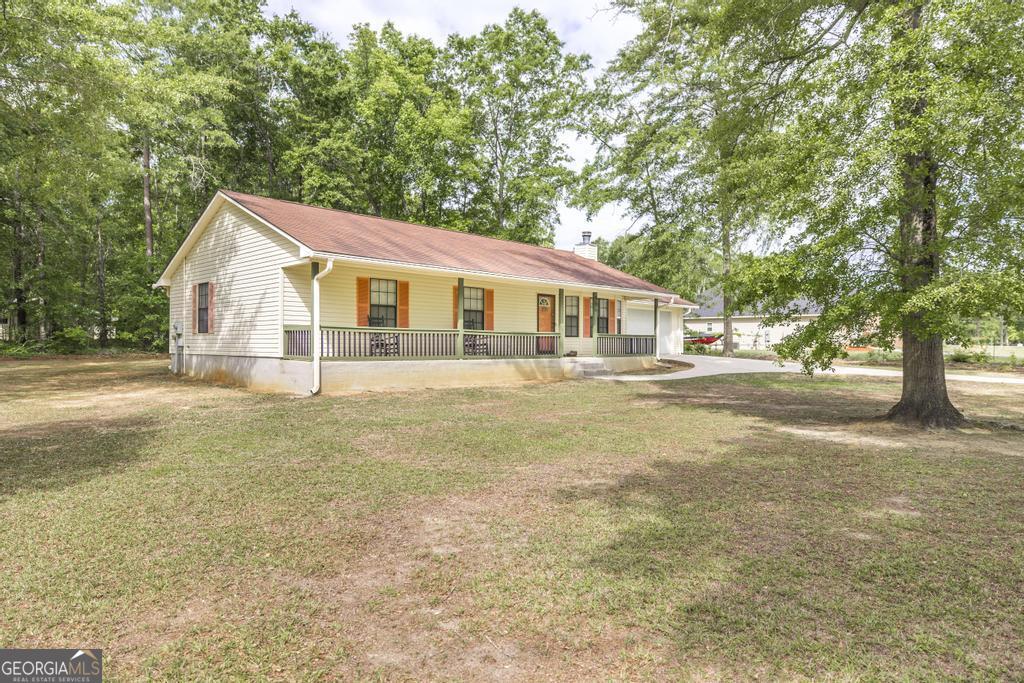 904 Robinhood Road Dublin, GA 31021 - Photo 2 of 29 a house view with swimming pool in front of it