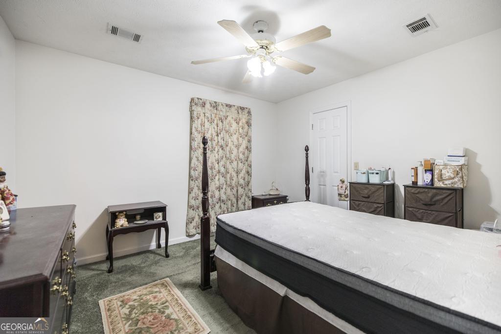 904 Robinhood Road Dublin, GA 31021 - Photo 21 of 29 a bedroom with a bed and a chandelier
