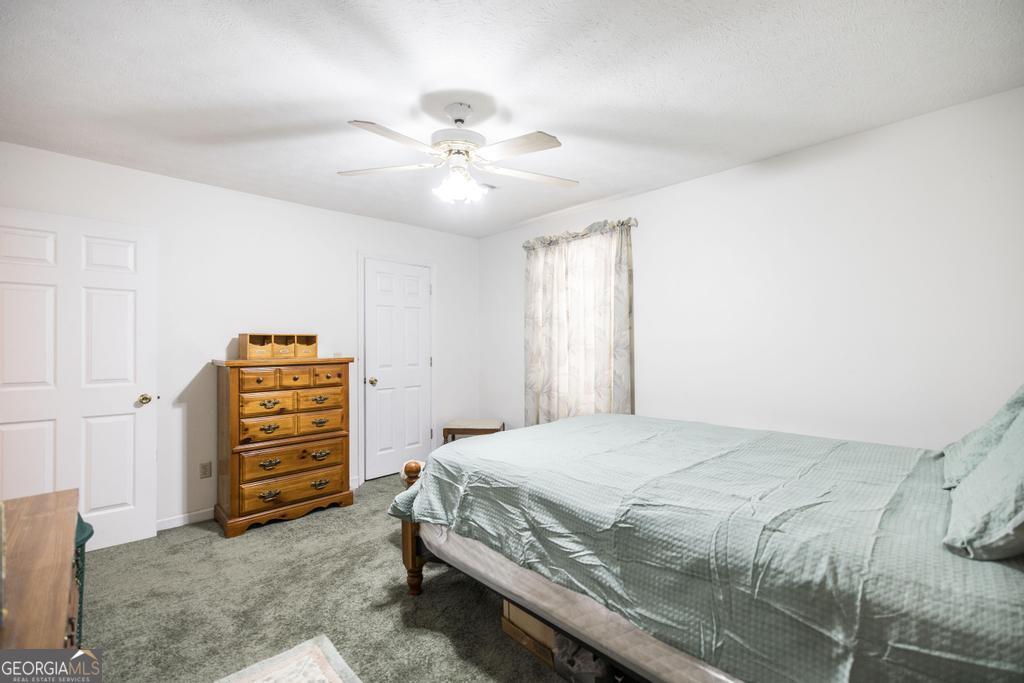 904 Robinhood Road Dublin, GA 31021 - Photo 23 of 29 a bedroom with a bed and a chandelier