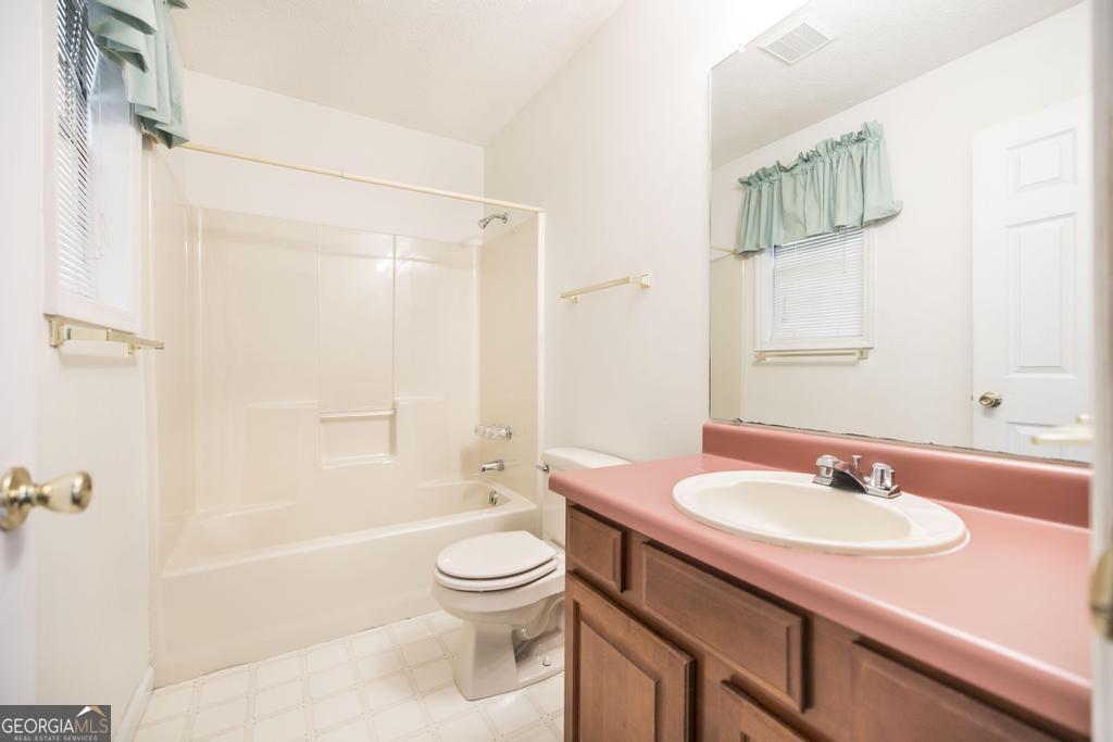904 Robinhood Road Dublin, GA 31021 - Photo 24 of 29 a bathroom with a sink toilet and shower