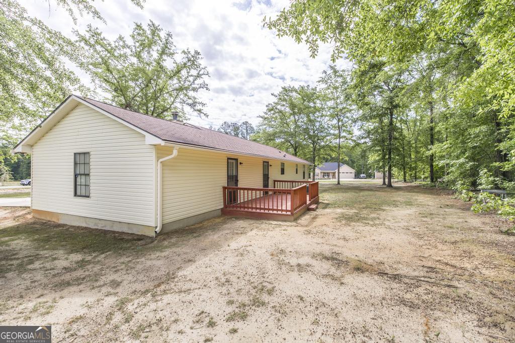 904 Robinhood Road Dublin, GA 31021 - Photo 26 of 29 a view of a house with backyard and trees
