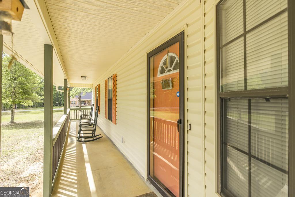 904 Robinhood Road Dublin, GA 31021 - Photo 7 of 29 a view of a balcony with wooden floor and door