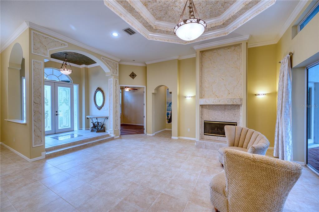 10523 Cheval Place Lakewood Ranch, FL 34202 - Photo 16 of 52 a living room with furniture and a fireplace