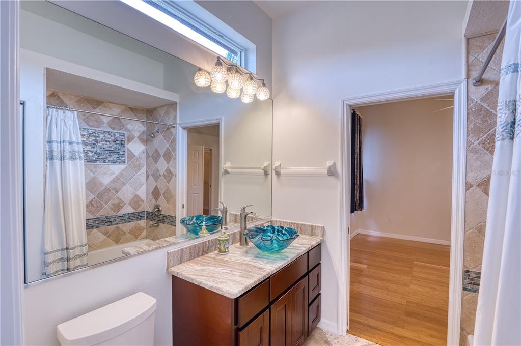 10523 Cheval Place Lakewood Ranch, FL 34202 - Photo 23 of 52 a bathroom with a granite countertop sink and a mirror