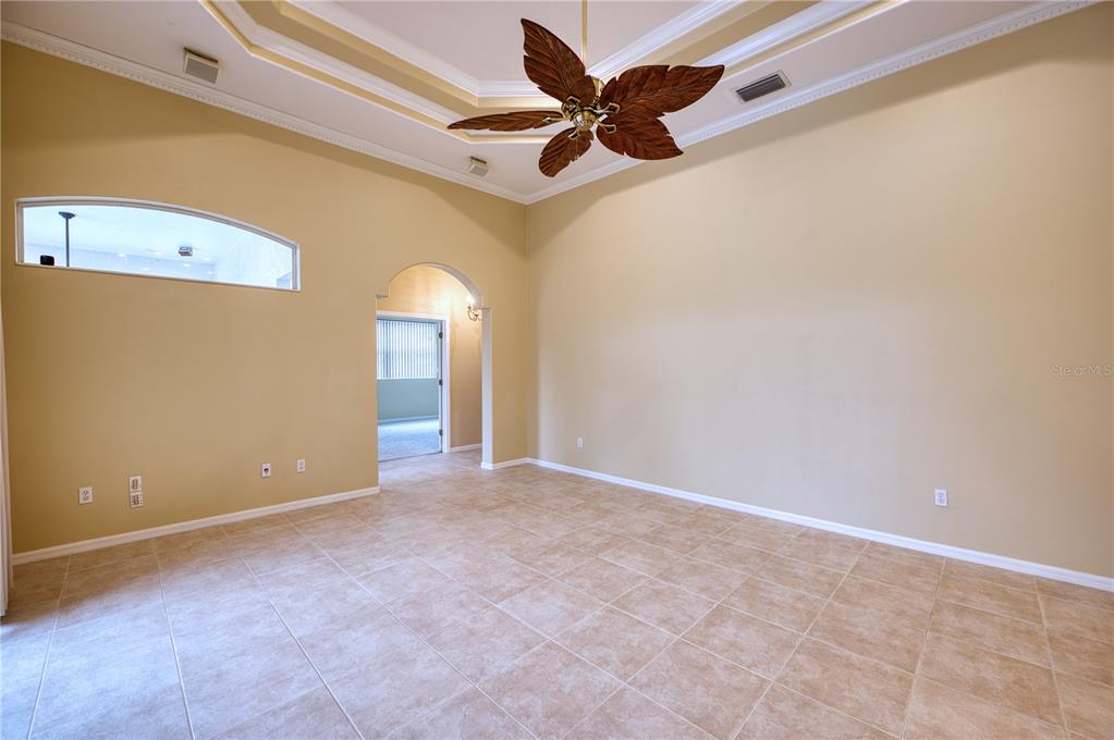 10523 Cheval Place Lakewood Ranch, FL 34202 - Photo 36 of 52 an empty room with a ceiling fan and carpet