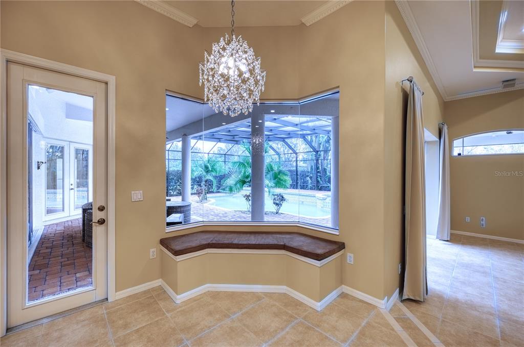 10523 Cheval Place Lakewood Ranch, FL 34202 - Photo 43 of 52 a room with chandelier and a large window