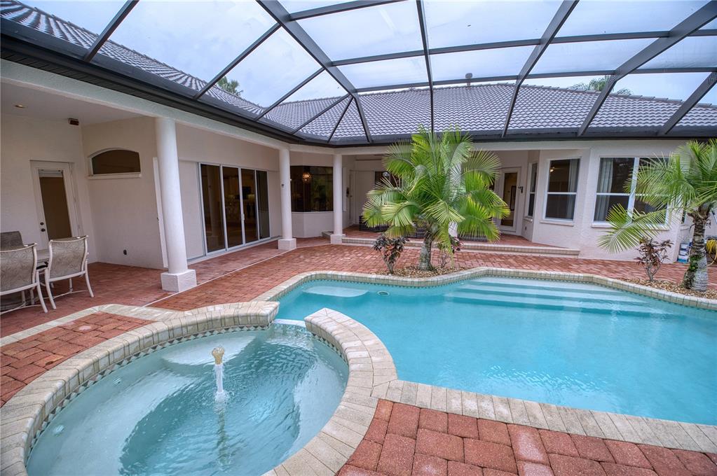 10523 Cheval Place Lakewood Ranch, FL 34202 - Photo 45 of 52 a view of a house with backyard sitting area and garden