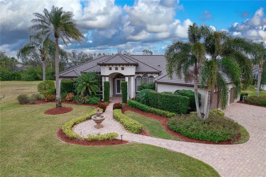10523 Cheval Place Lakewood Ranch, FL 34202 - Photo 52 of 52 a front view of a house with garden