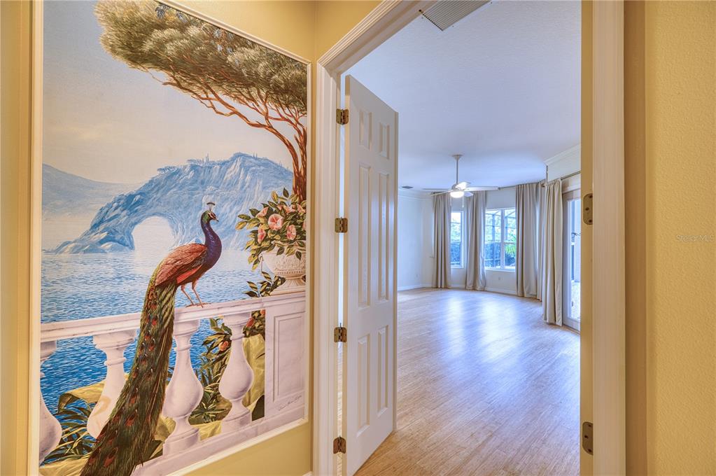 10523 Cheval Place Lakewood Ranch, FL 34202 - Photo 6 of 52 a view of a hallway view with wooden floor and staircase