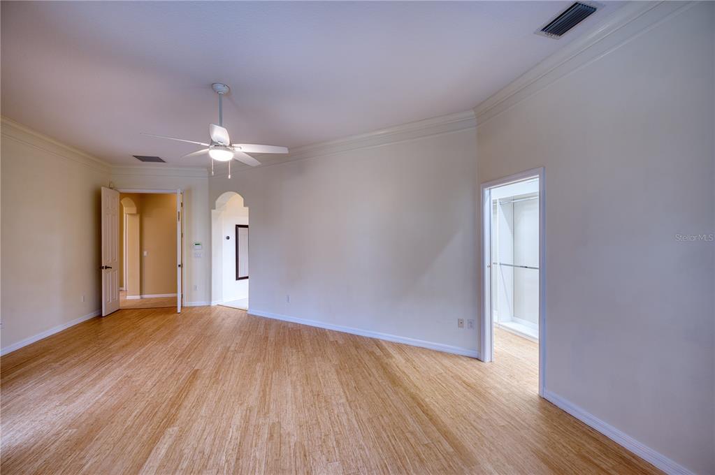 10523 Cheval Place Lakewood Ranch, FL 34202 - Photo 8 of 52 wooden floor in an empty room with a window