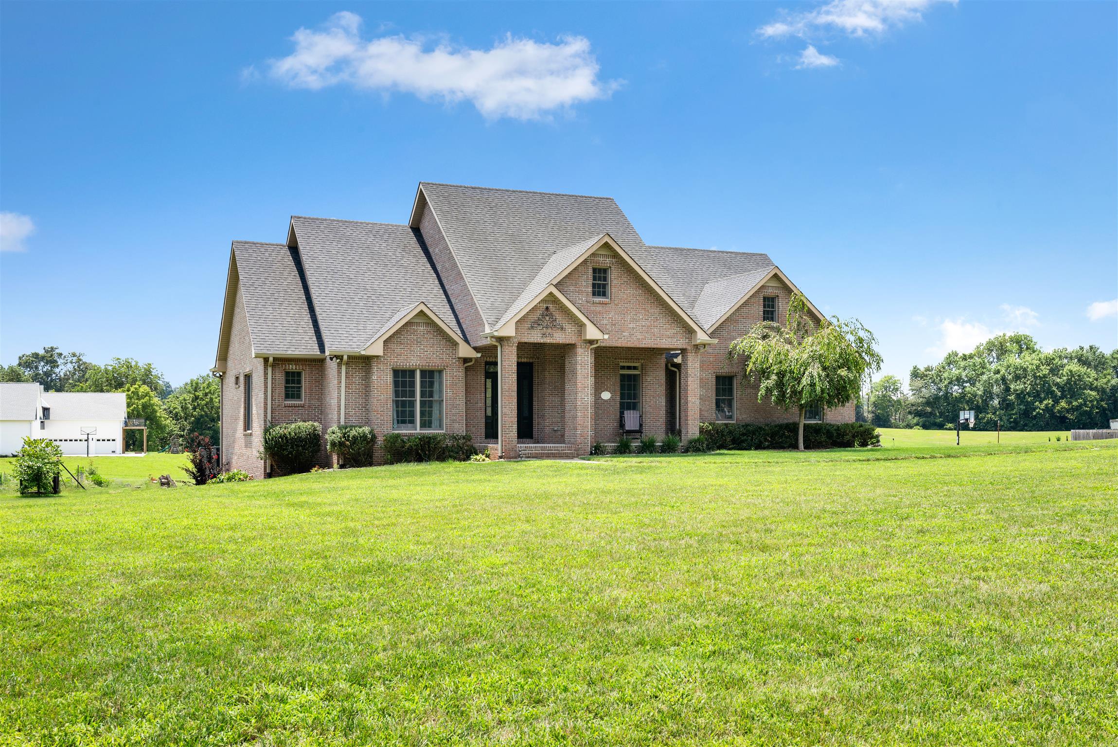 2570 Gunn Road Adams, TN 37010 - Photo 1 of 27 a front view of a house with a big yard