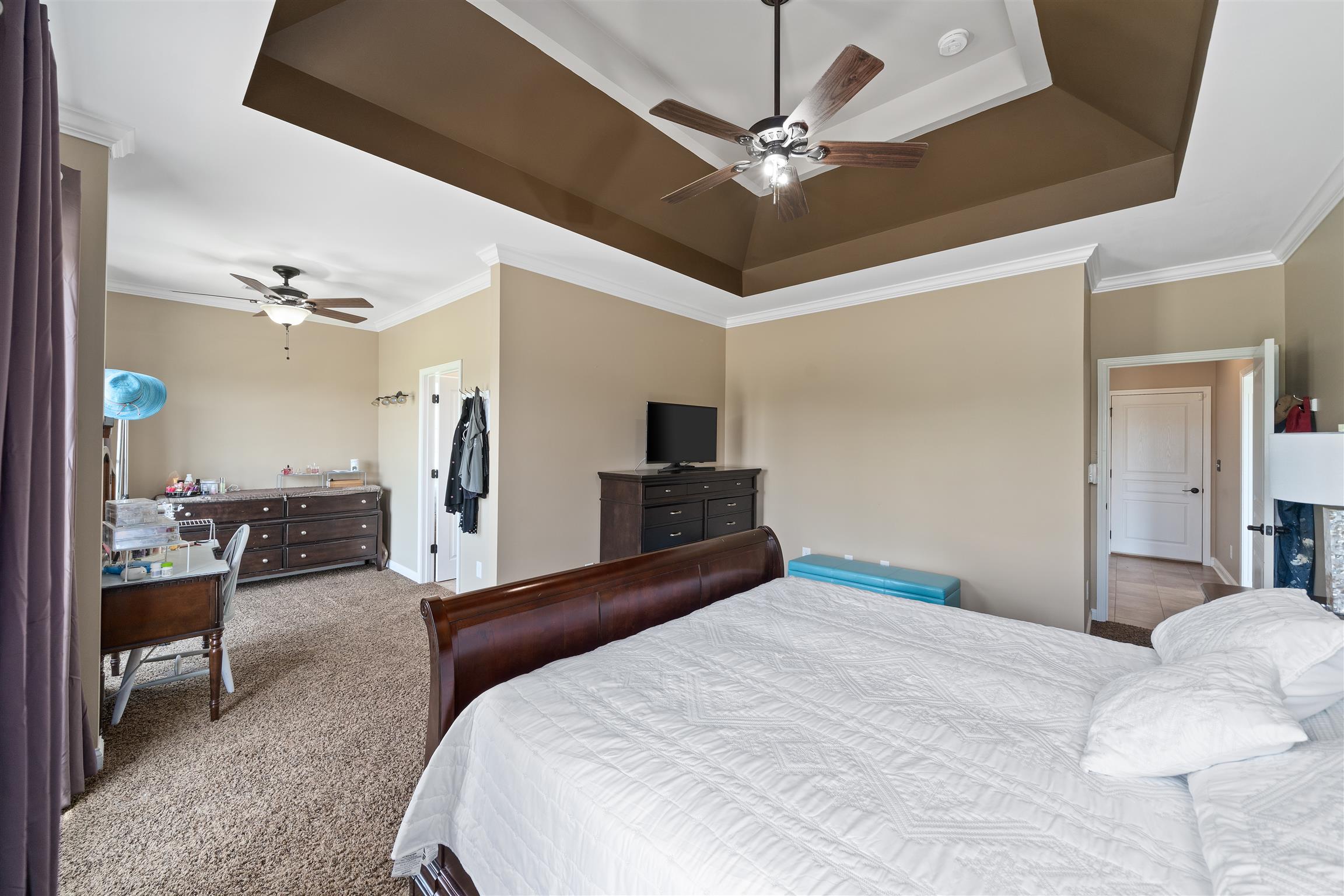 2570 Gunn Road Adams, TN 37010 - Photo 16 of 27 a bedroom with a large bed and a chandelier