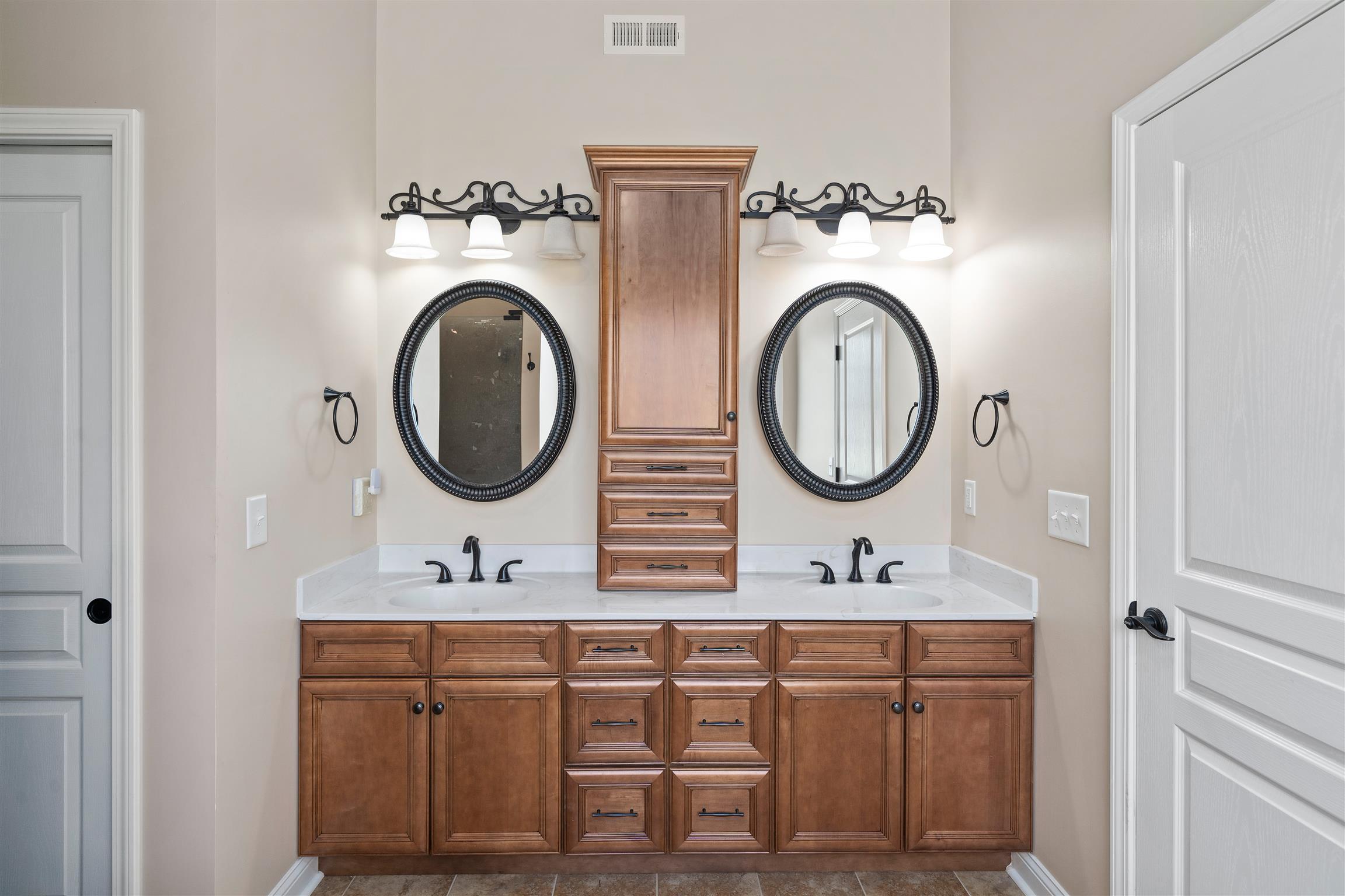 2570 Gunn Road Adams, TN 37010 - Photo 18 of 27 a bathroom with a double vanity sink and a mirror