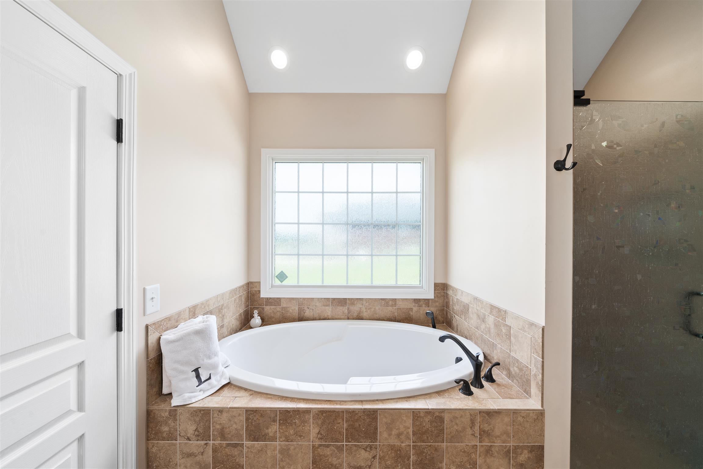 2570 Gunn Road Adams, TN 37010 - Photo 19 of 27 a white bath tub sitting in a bathroom next to a window
