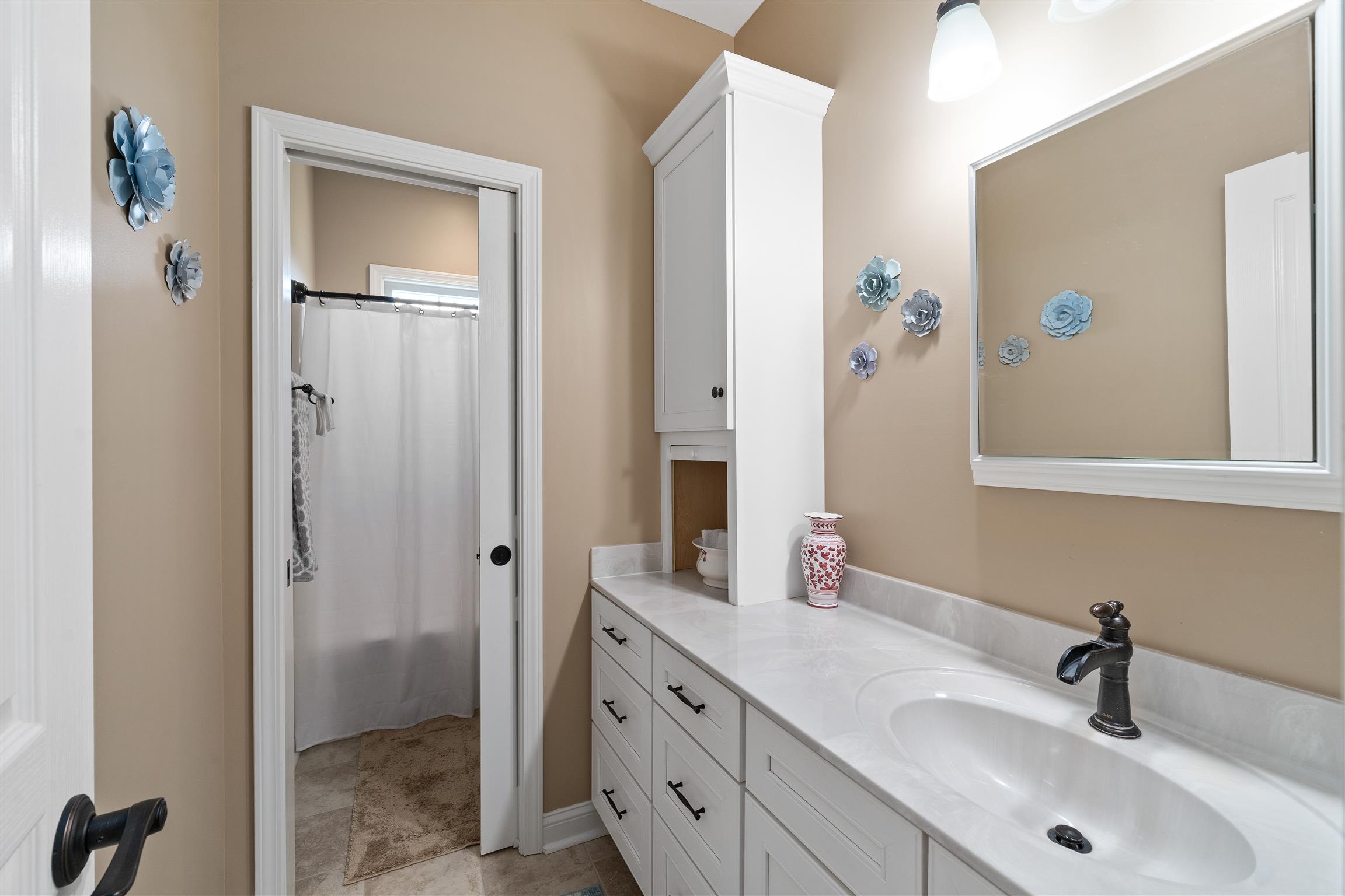 2570 Gunn Road Adams, TN 37010 - Photo 23 of 27 a bathroom with a double vanity sink and mirror