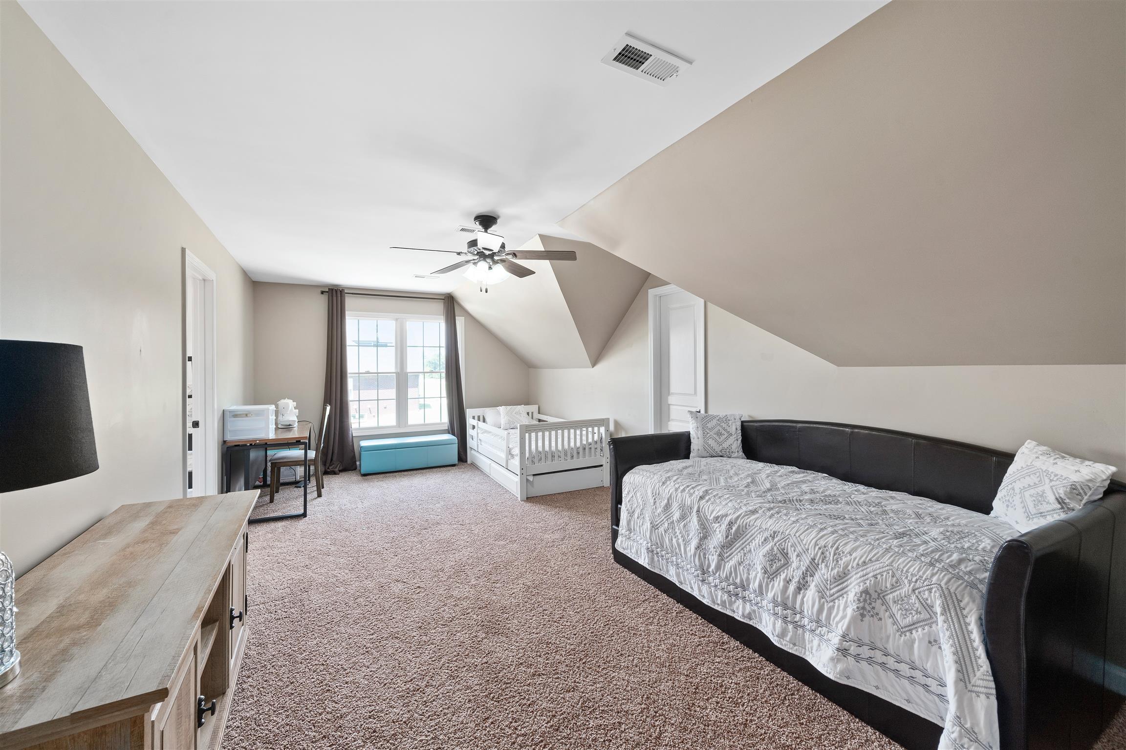 2570 Gunn Road Adams, TN 37010 - Photo 25 of 27 a bedroom with bed and a chandelier
